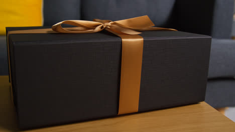 Close-Up-Of-Gift-Wrapped-Present-With-Bow-On-Table-In-Lounge-At-Home-4